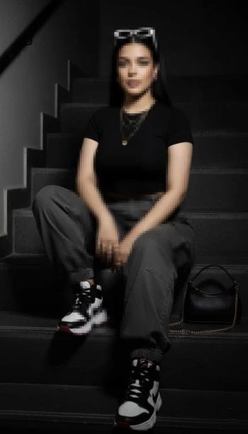 Stylish Woman Sitting on Stairs in a Modern Urban Streetwear Look