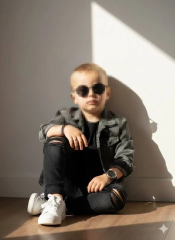 Stylish Young Boy Posing Confidently in Sunlight with a Cool Fashion Look
