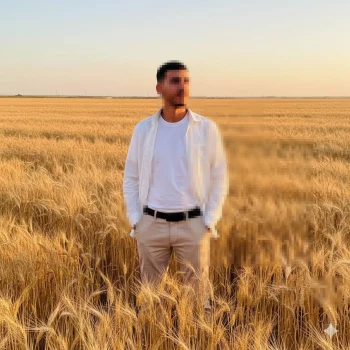 Sunset Portrait of a Man Standing in a Golden Wheat Field
