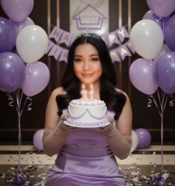 Woman celebrating her 31st birthday with lavender cake and purple balloon decor