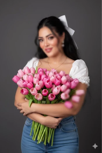 Woman Holding Pink Tulip Bouquet in Elegant White Blouse and Blue Jeans