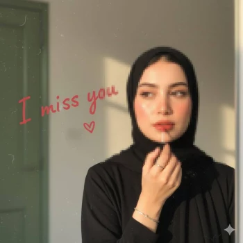 Woman in black hijab applying lip gloss under warm sunlight with I miss you text
