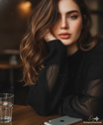 Woman in black sweater sitting thoughtfully at a cozy café table