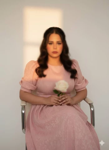 Woman in Light Pink Dress Holding White Rose Under Soft Sunlight