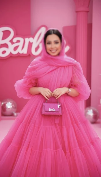Woman in Pink Tulle Dress Holding Barbie Bag in Vibrant Fashion Studio