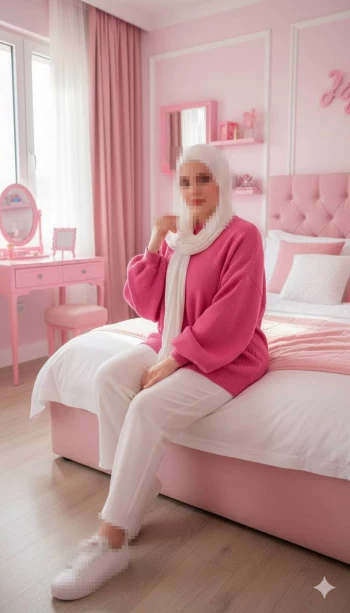 Woman in White Hijab and Pink Sweater Sitting in Stylish Pink Room