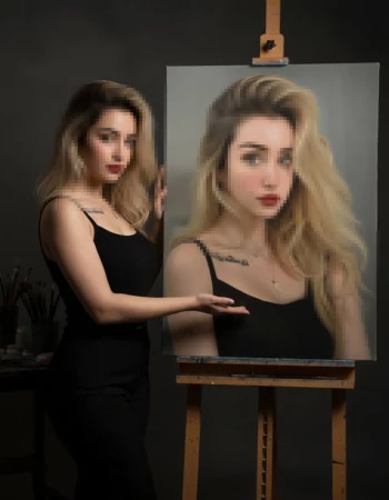 Woman presenting a realistic portrait painting of herself in art studio