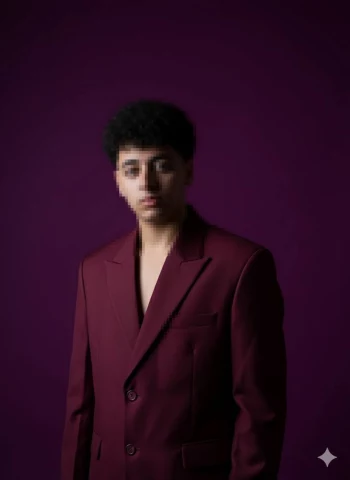 Young Man in Maroon Suit Posing Confidently Against Purple Background